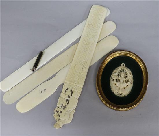 Four ivory or bone page turners and an Indian ivory pendant (framed)